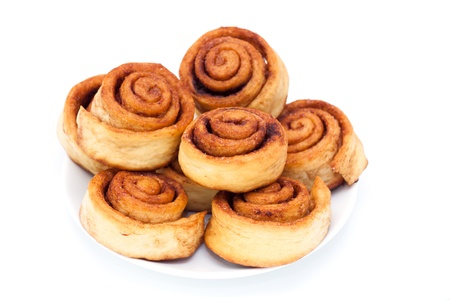 Cinnamon rolls group on the plate, white backgroundの写真素材
