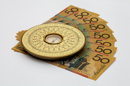 Chinese Feng Shui compass on top of Australian Moneyの写真素材