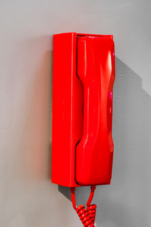 Emergency red telephone in an office buildingの写真素材