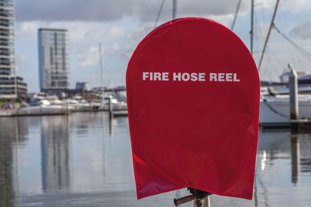 Red Firehose by the docks in Docklandsの写真素材