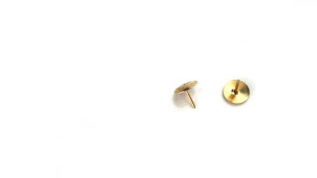 Gold push pins isolated on white backgroundの写真素材