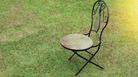 Old wooden chair on a green grassの写真素材