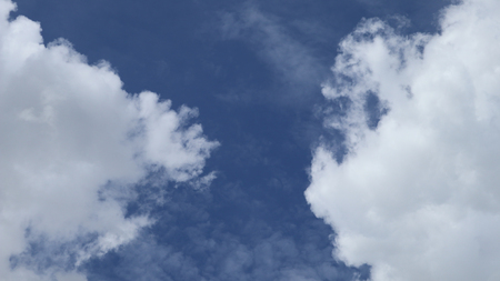 Blue sky background with tiny clouds. Beautiful clouds on blue skyの写真素材