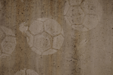 football print on cement background,soccer slough on wallの写真素材