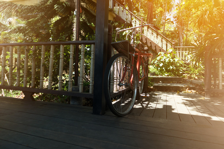 Old Bicycle on wooden floor. vintage house and nature background.の写真素材