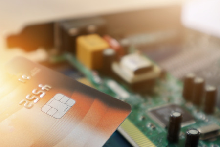 Credit card on circuit Mainboard of computer. Financial and technology Concept