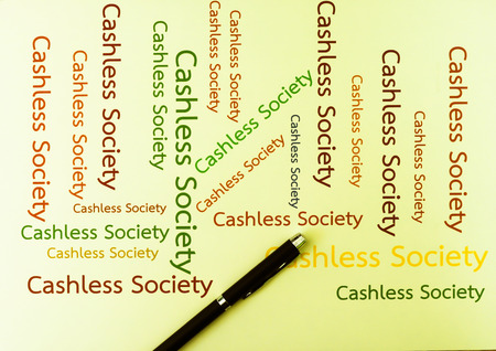 Cashless Society Concept pay with Application mobile phone. Wording Cashless Society paper on backgroundの写真素材