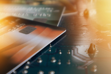 Credit card on circuit Mainboard of computer. Financial and technology Concept blurred backgroundの写真素材