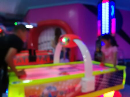 blurred place for play a game child in department store. Playground with colorful neon light and bokeh lightの写真素材