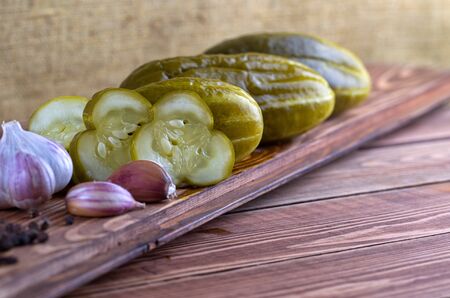 Pickles in can with garlic and pepper on a tableの写真素材