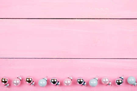 Brilliant christmas bauble and ornaments on a pink tableの写真素材