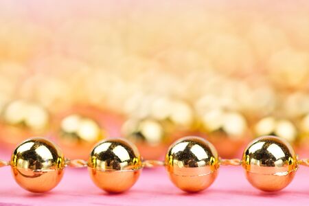 Brilliant christmas bauble and ornaments on a pink tableの写真素材