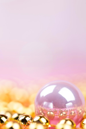 Brilliant christmas bauble and ornaments on a pink tableの写真素材