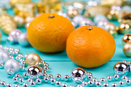 Tangerines and baubles on a wooden tableの写真素材
