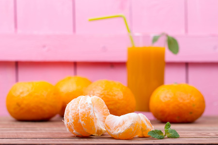 Tangerines and juice with pulp on a tableの写真素材