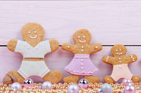 Homemade baked Christmas gingerbread man on vintage wooden background. Anise, cinnamon and...