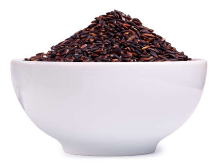 Black rice in a glass bowl isolated on a white backgroundの写真素材