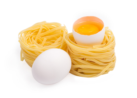 Eggs and paste tagliatelleon isolated on the white backgroundの写真素材