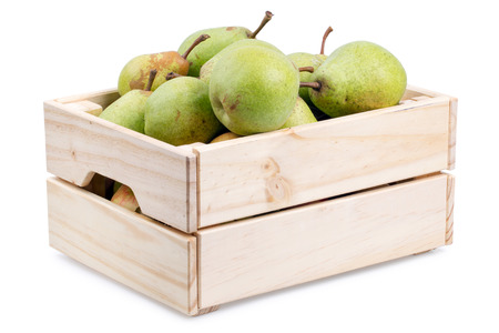 Wooden box full of fresh pears isolated on a white backgroundの写真素材