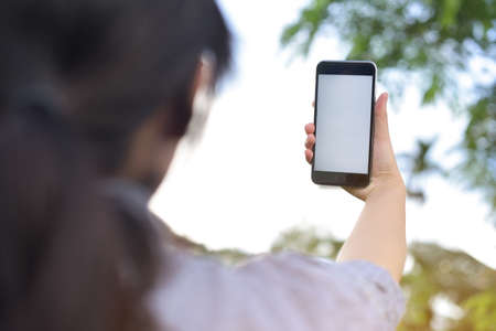 Hands hold smartphone with graphs marketing and cyber technology background. Marketing checking on smartphone. cyber graph and technology. Selective focusの写真素材