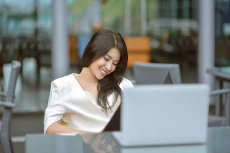 Successful entrepreneurs and business people achieving goals, Happy business people celebrating success at company, Business woman with arms up leading a successful team.の写真素材