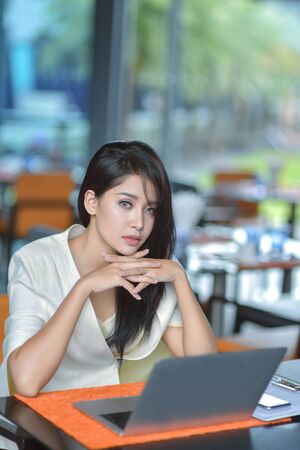 Business woman in cafe with laptopの写真素材