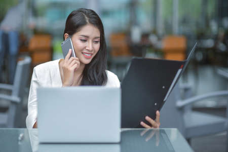 Successful entrepreneurs and business people achieving goals, Happy business people celebrating success at company, Business woman with arms up leading a successful team.の写真素材