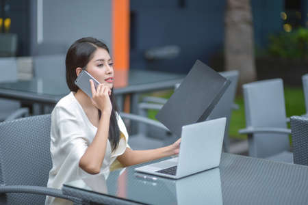 Successful entrepreneurs and business people achieving goals, Happy business people celebrating success at company, Business woman with arms up leading a successful team.の写真素材