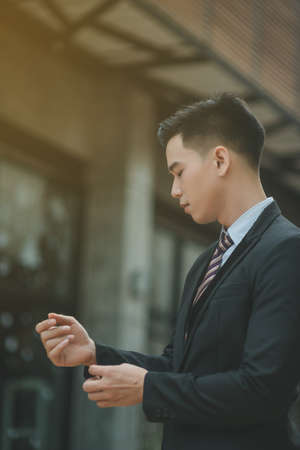 Successful entrepreneurs and business people achieving goals, Happy business people celebrating success at company, Business man with arms up leading a successful team.の写真素材
