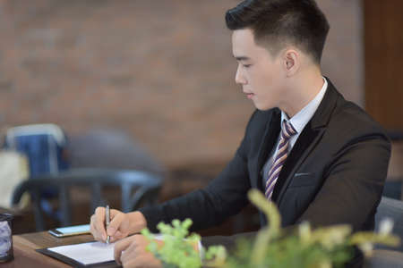 Successful entrepreneurs and business people achieving goals, Happy business people celebrating success at company, Business man with arms up leading a successful team.の写真素材