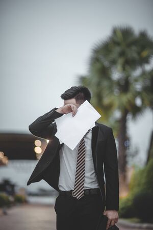 Asian Business Employee Feeling Sad or Sadness, Sitting on Floor and Drinking Some Alcoholic. He Losing His Job. Low Employment, High Unemployment Rate, Business People Feeling Depressed And Worry.の写真素材
