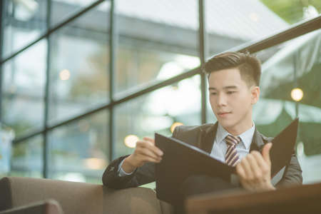 Successful entrepreneurs and business people achieving goals, Happy business people celebrating success at company, Business woman with arms up leading a successful team.の写真素材