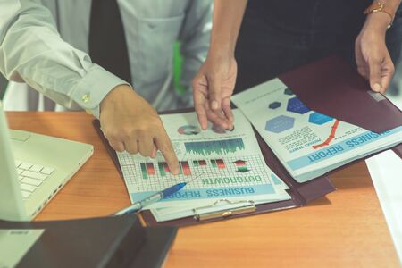 Group of business people analysis with marketing report graph, Young specialists are discussing business ideas for new digital start up project, Financial, accounting, investment, Selective focus.の写真素材