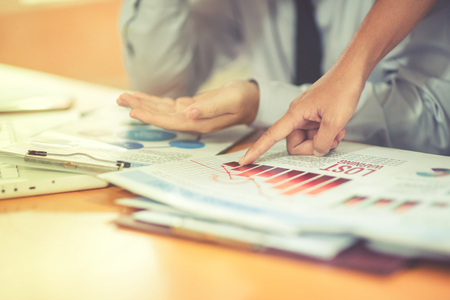 Group of business people analysis with marketing report graph, Young specialists are discussing business ideas for new digital start up project, Financial, accounting, investment, Selective focus.の写真素材