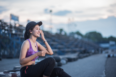 Young woman runner is jogging on the street be running for exercise.の写真素材