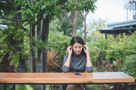 Portrait of young businesswoman use mobile phone while sitting in comfortable coffee shop during...