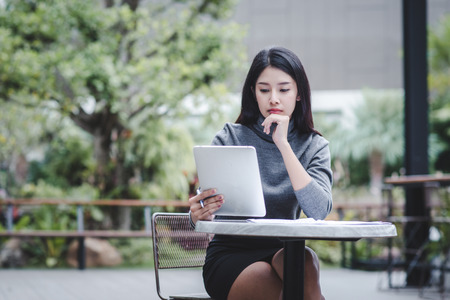 Business woman holding a tablet computer for trading stocksの写真素材