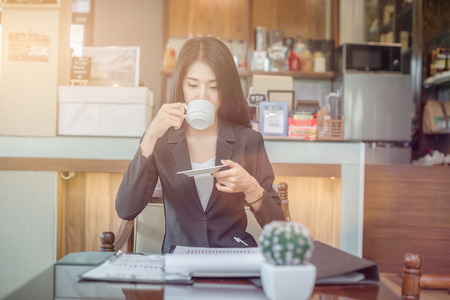 Successful entrepreneurs and business people achieving goals, Happy business people celebrating success at company, Business woman with arms up leading a successful team.の写真素材