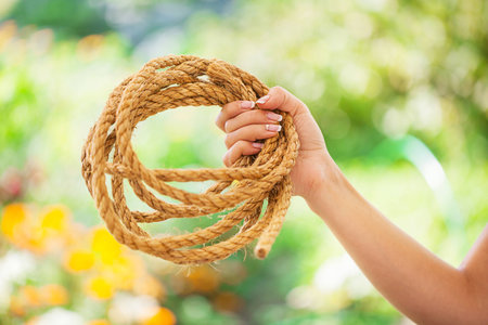 woman keep rope green backgroundの写真素材