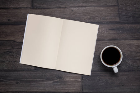 Cup coffee on wooden background with empty note, top viewの写真素材