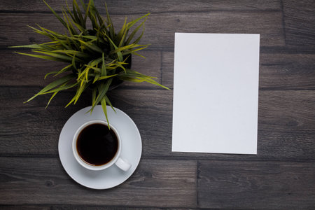 Cup coffee on wooden background with empty note, top viewの写真素材