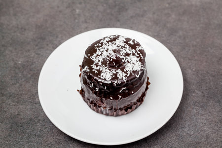Chocolate cake on kitchen table. Close up.