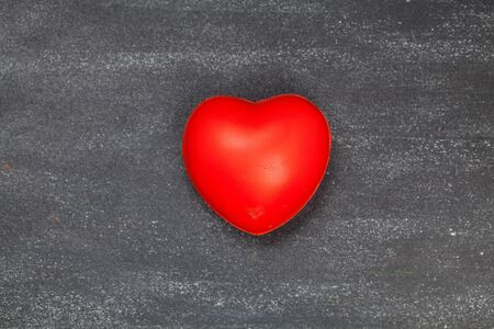 red heart on black board