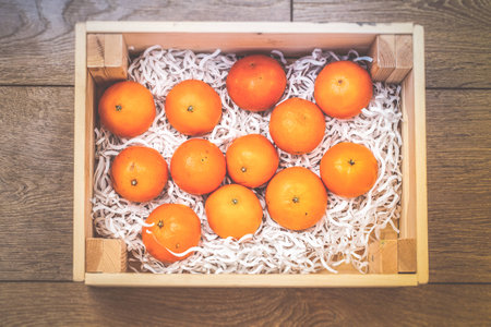 tangerine in wooden boxの写真素材