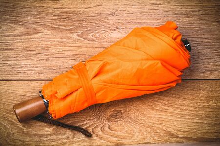 orange umbrella on wooden table