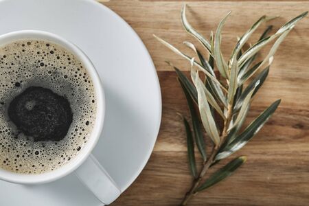 Cup of coffee on wooden table with copy space.