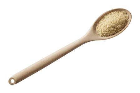 Wheat groats in wood spoon. Preparing ingredients for cooking.の写真素材