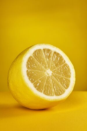 Fresh lemon on yellow background. Front view.の写真素材