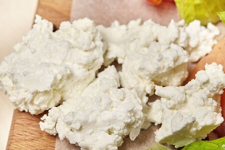 Cottage cheese on kitchen table. Preparation for cooking. Close up.