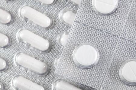 White pills tablets in package. Pharmacy and medicine background.
